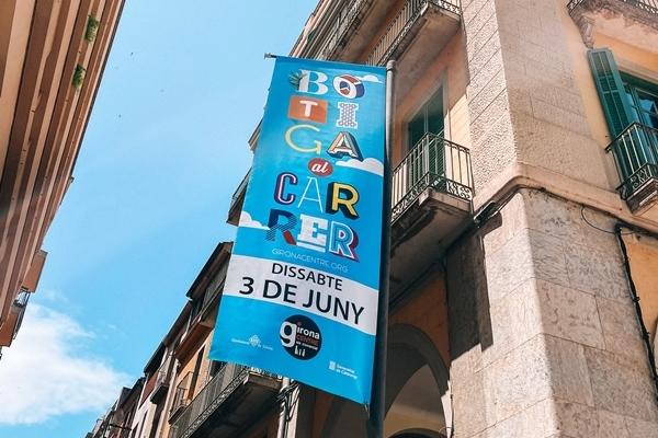 Banderola amb imatge de la campanya Botiga al carrer ubicada entre dos carrers