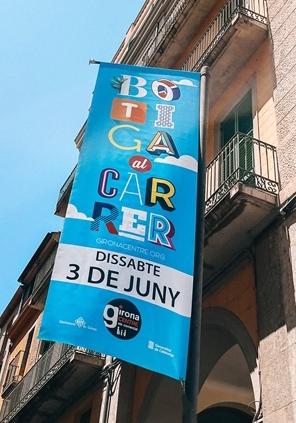 Banderola amb imatge de la campanya Botiga al carrer ubicada entre dos carrers